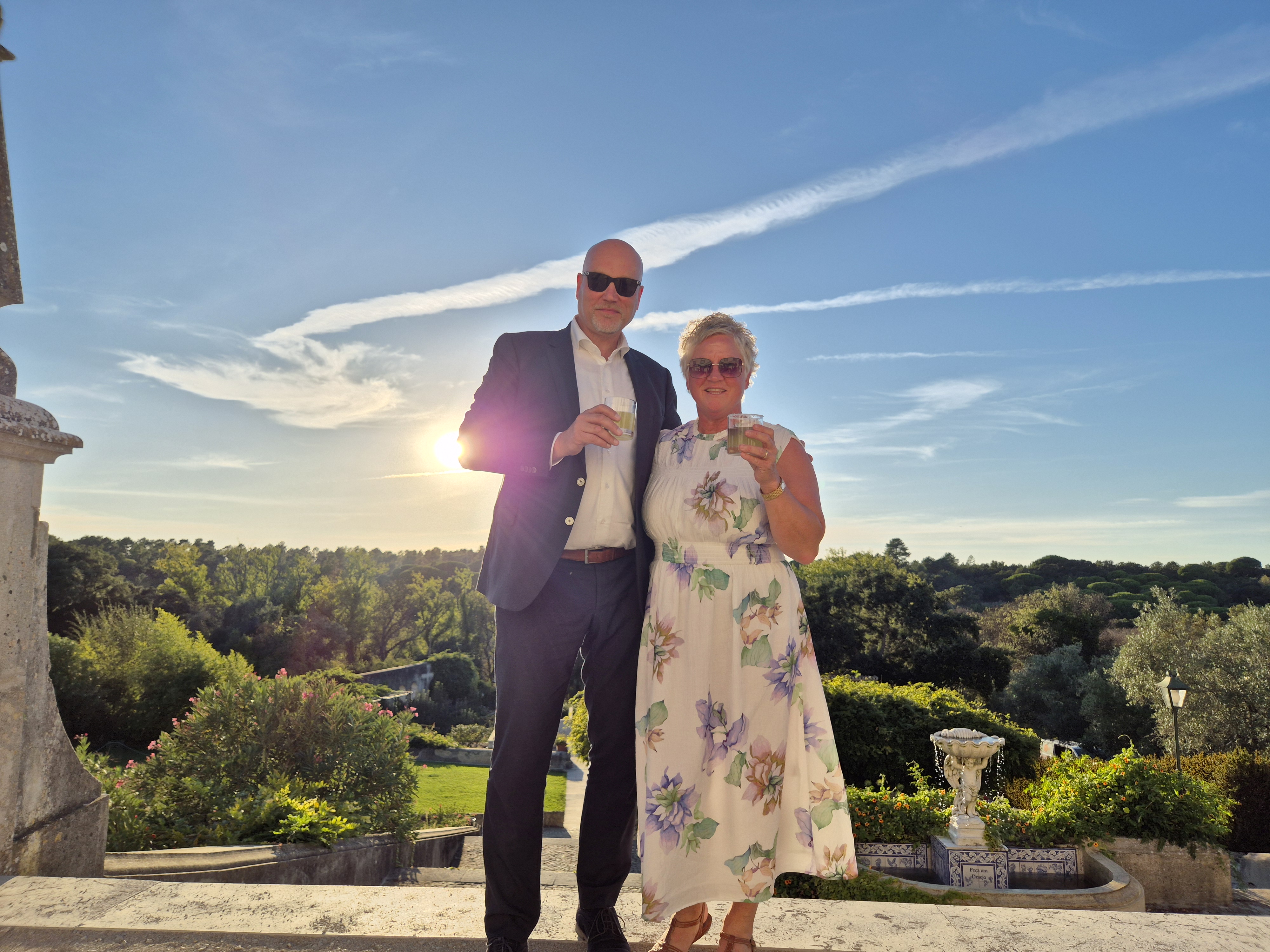 Hans Krijger with blonde hair, smiling softly, with the head of a dark horse positioned closely beside her